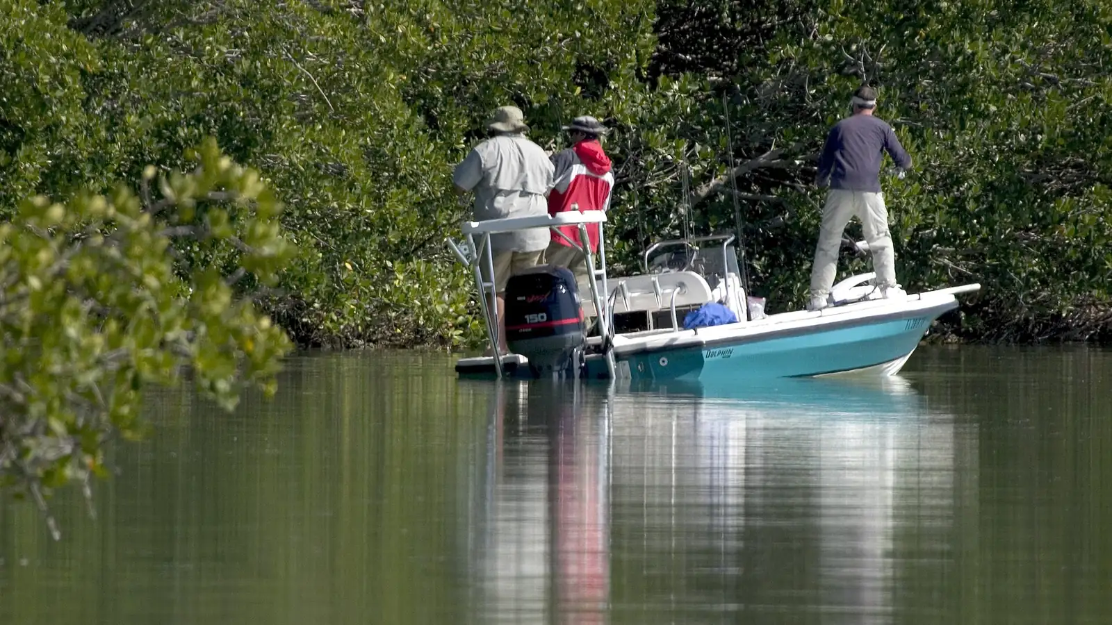Two anglers fishing from a skiff on the calm water of Florida Bay
